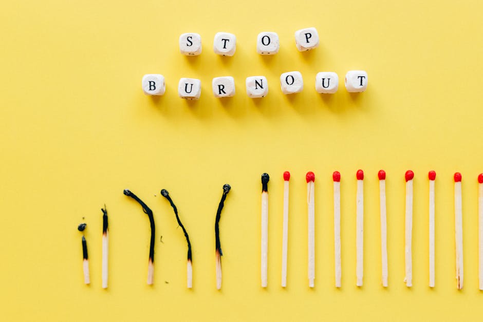 Napis „STOP BURNOUT” z klocków oraz rząd częściowo spalonych i całych zapałek.